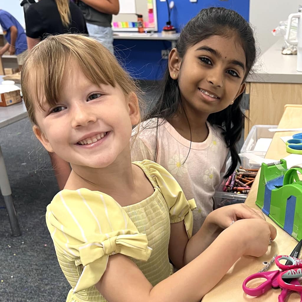 Two young students in a classroom