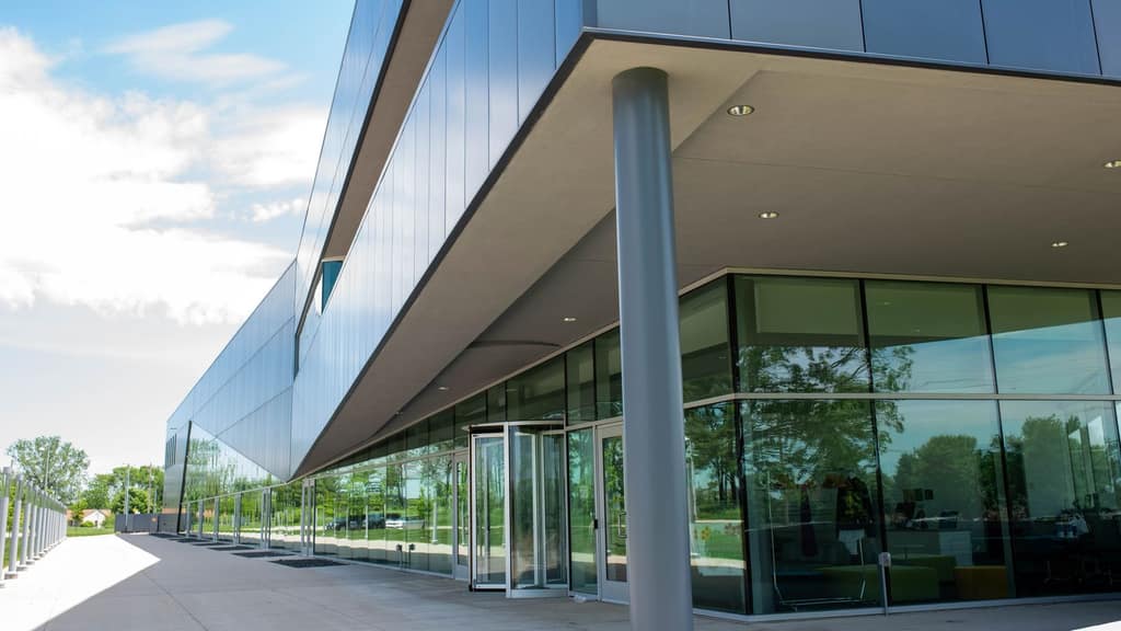 Glass-walled exterior of a modern Waukee school building