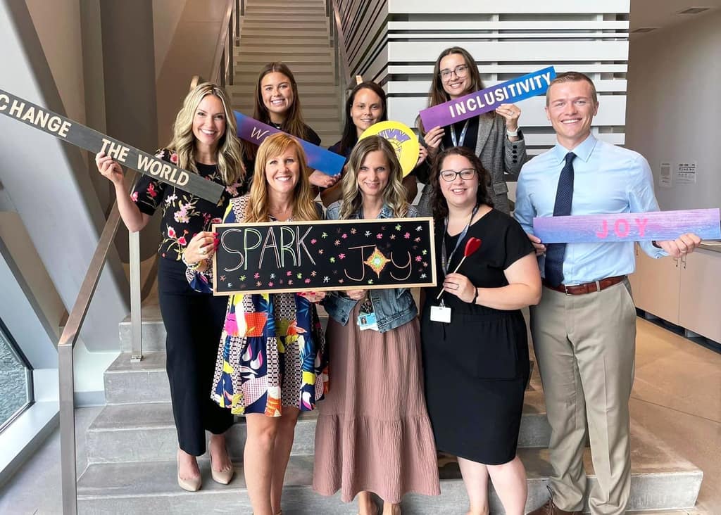 Waukee CSD staff holding positivity signs