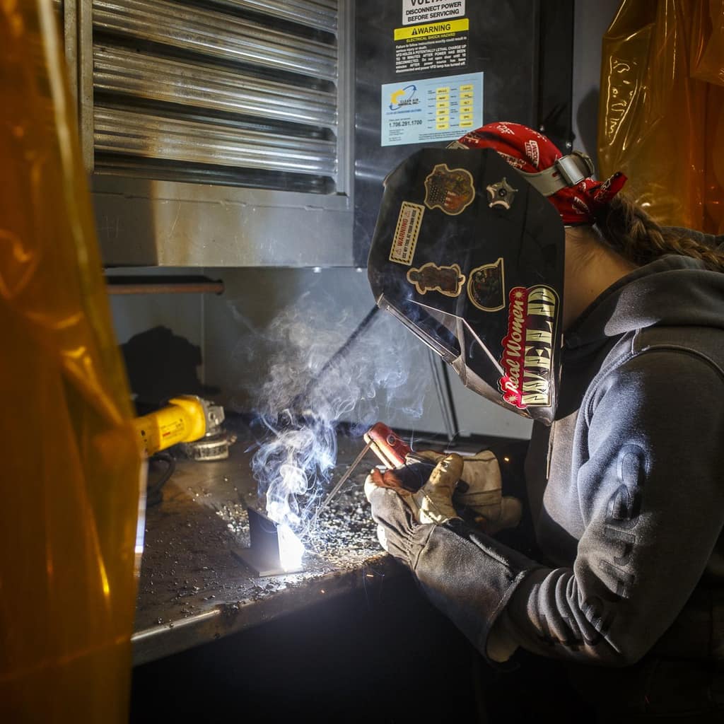 A student welding in a Waukee career lab